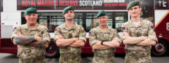 Royal Marines Reserve stand in front of bus