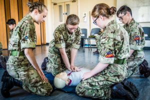Four Cadets practicing first aid on dummy