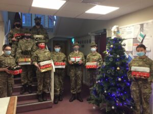 Cadets holding Christmas presents