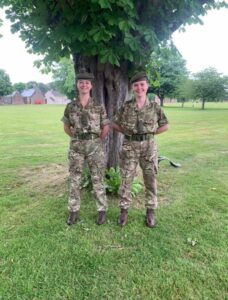 Two females in Army green uniform