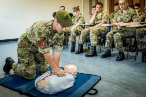 Cadet performing CPR on dummy