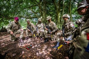 Adult Volunteer and Cadets training in woodland