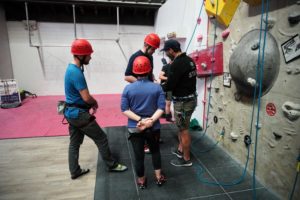 Reservists gather round instructor at climbing wall