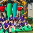 Cadets and Children sit on a bouncy castle
