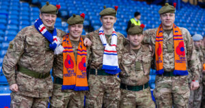 Armed Forces personnel sporting their Rangers scarves with their uniforms at the Rangers FC Armed Forces Day