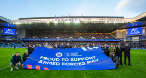Military guests at Ibrox stadium displaying a Rangers FC Armed Forces banner