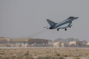 This image shows an RAF Typhoon taking off from Thumrait at the start of Ex MAGIC CARPET 2021. RAF Typhoon jets and a Voyager air-to-air refueller arrived at Thumrait Air Base, Oman, this week to prepare for Exercise MAGIC CARPET, an annual bilateral exercise with the Royal Air Force of Oman (RAFO). The Typhoons, (II(AC) Sqn RAF Lossiemouth and 12 Sqn RAF Coningsby) and a Voyager (RAF Brize Norton) with over 300 RAF support personnel arrived safely and are now preparing for the two-week exercise in southern Oman. The Royal Air Force will be working with the Royal Air Force of Oman to deliver challenging training to RAF and Omani pilots, comprising of air-to-ground missions and air-to-air refuelling of aircraft. The exercise strengthens the RAFs role as a key partner for Oman, demonstrates its ability to deploy world class capabilities and deliver high quality training opportunities. This bilateral, multi-domain exercise, while not unique, provides further evidence of the United Kingdoms integrated approach to defence and foreign policy and the UKs enduring commitment to working with Oman and Gulf partners on promoting regional security and stability.