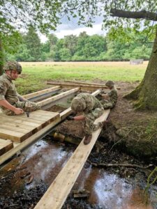 Reservists building a wooden bridge over a stream in Sennelager, Germany.