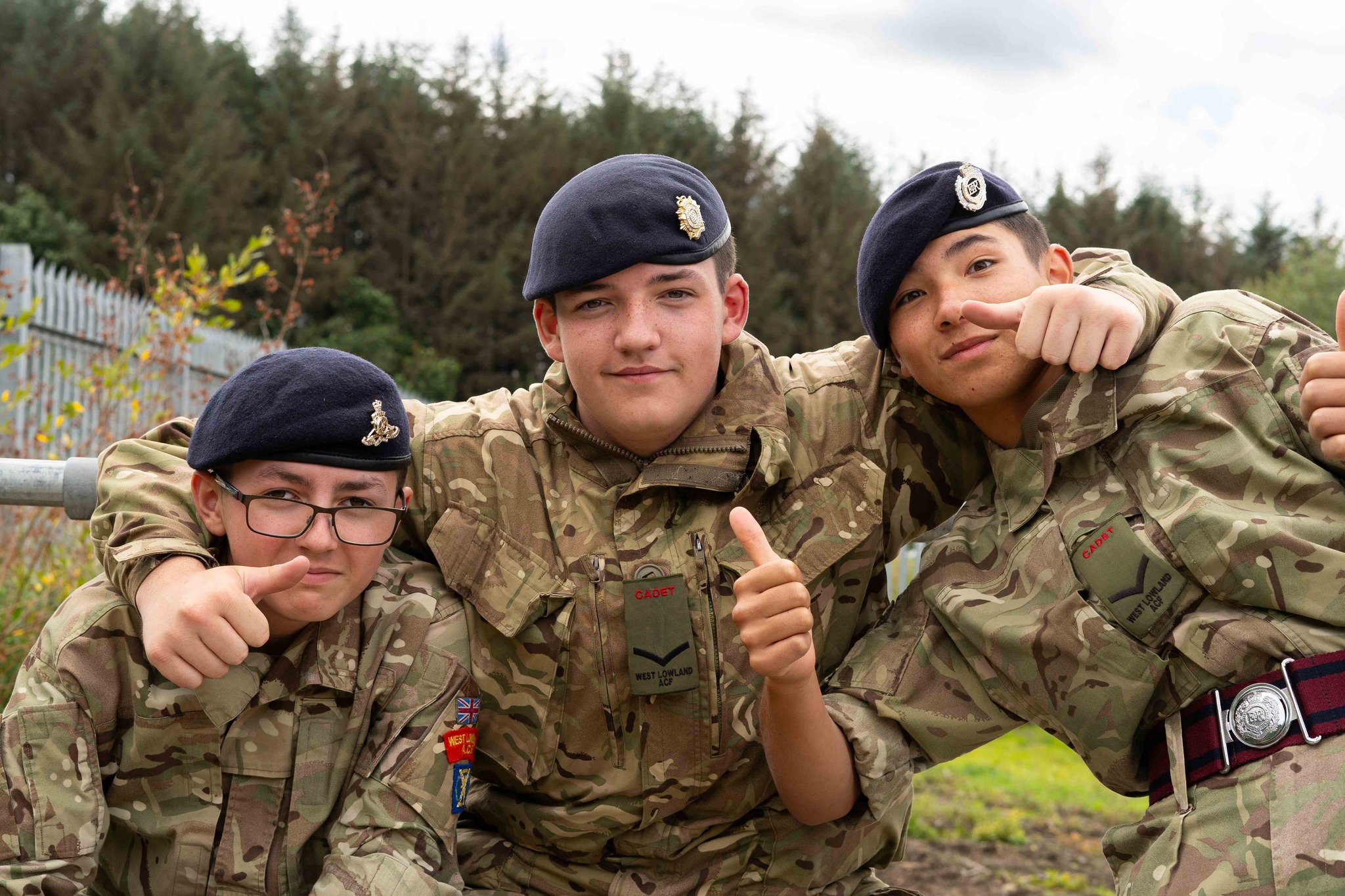3 Cadets smile at the camera