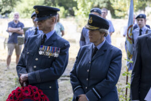 Squadron Leader Derek Read, left, and Air Commodore Jane Middleton, right, stand ready to lay wreaths at the grave of Flight Lieutenant Freddie Rushmer.