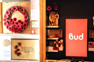 A selection of exhibits and interactive activities on Bud, including a 100 year old poppy wreath, an audiovisual display and poppies used to reflect different faiths.