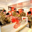 Learning and Outreach officer Catherine Provan instructs a group of Cadets how to make their own poppies.