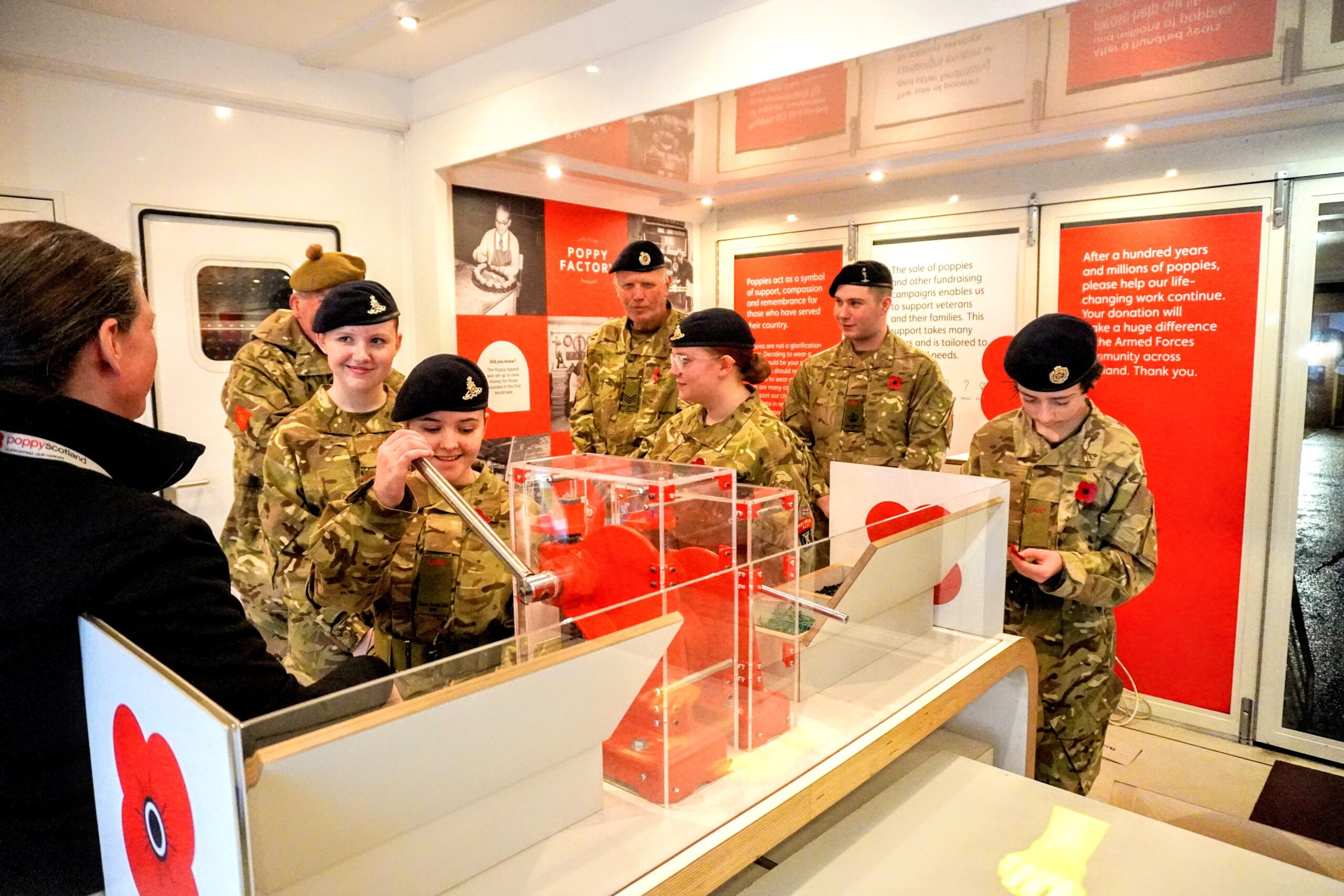Learning and Outreach officer Catherine Provan instructs a group of Cadets how to make their own poppies.