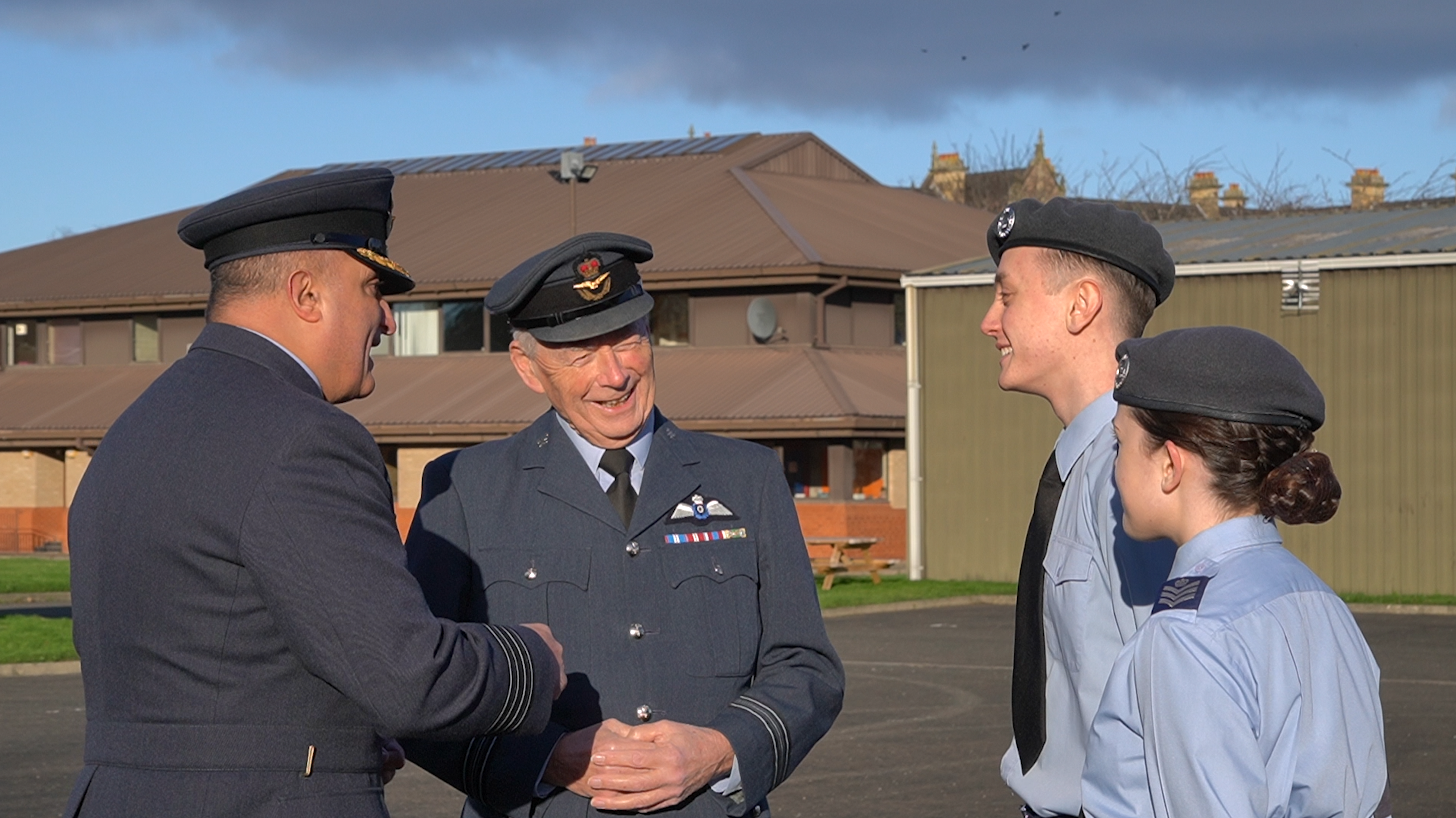 Left to right: Group Captain Khan, Squadron Leader Gray, Flight Sergeant Edwards and Flight Sergeant Moonie chatting together outside Artillery House