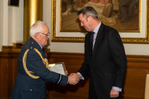 Matthew Quinn of Future Sales Factory shakes hands with Air Officer Scotland Air Commodore Bill Gibson as he receives his ERS Gold revalidation