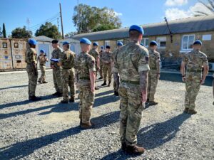 Army Regulars mobilised to cover Reservists on leave receive their UN medals at Blue Beret Camp.
