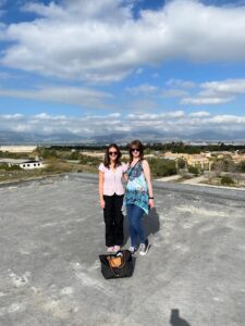 Head of Communications Kate Johnston and Communications Officer Emma McMullan standing on the roof of the abandoned Nicosia International Airport. The Kyrenia mountains in the north of the island can be seen in the background.