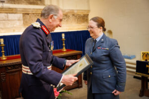 Flight Lieutenant Vanda Nicholls enjoys a moment of chat with Colonel McCarthy before receiving her Certificate of Meritorious Service.