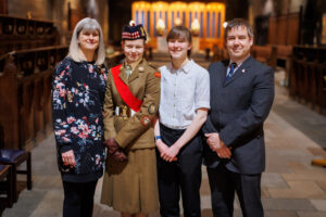 Cadet Sergeant Major Howie posing with her family in Paisley Abbey before the start of the award ceremony