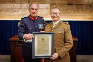 Captain Dave Hanley standing with Colonel Peter McCarthy for an official photo after being presented with a framed Certificate of Meritorious Service