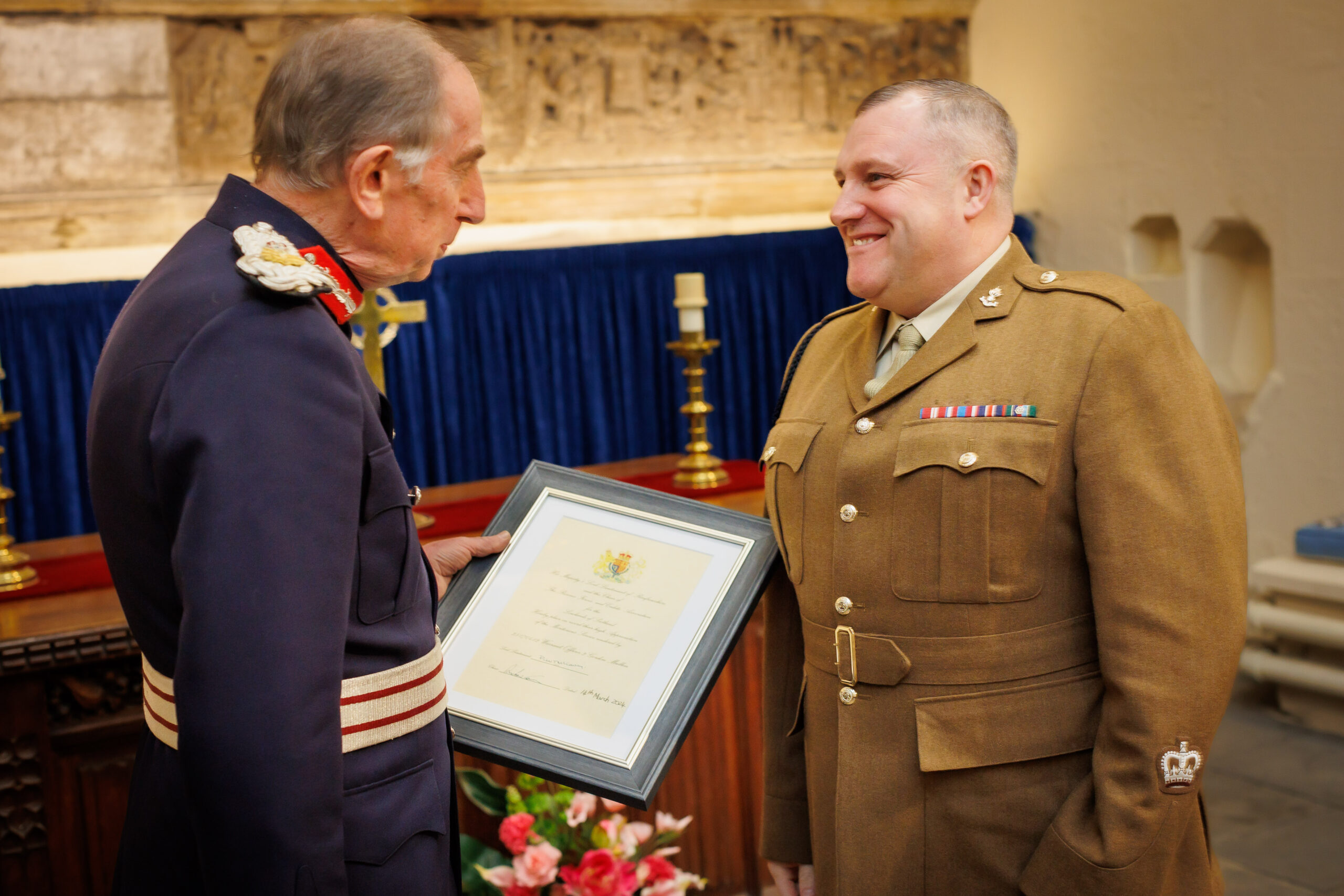 Colonel Peter McCarthy presents a framed Lord-Lieutenant's Certificate to 102 Field Squadron's Warrant Officer 2 Gordon Mullen