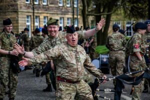 Adult instructors enjoying a light hearted photo op during Beating Retreat rehearsals
