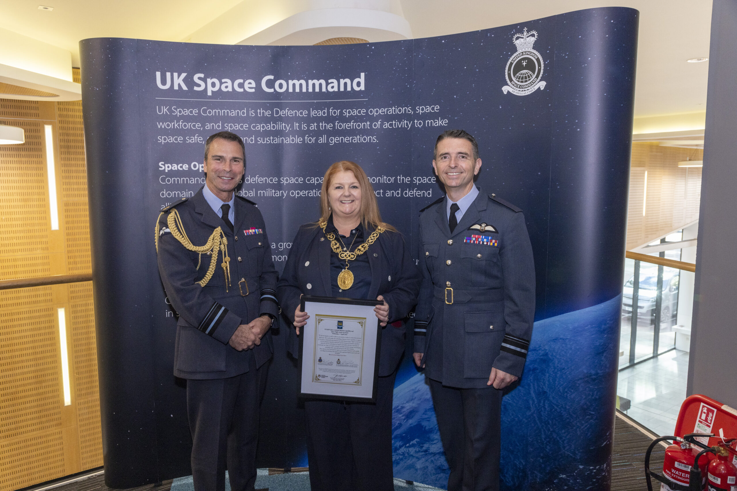 Lord Provost of the City of Glasgow Jacqueline McLaren stands between two RAF Reserve personnel at the 602 Squadron Space unit formation ceremony.